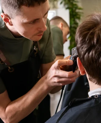 man-cutting-client-s-hair