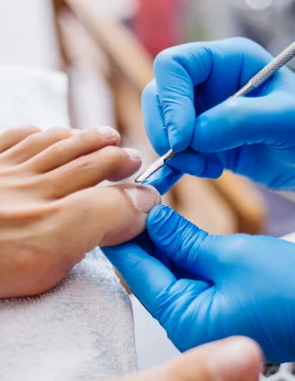pedicure-process-home-salon-pedicure-foot-care-treatment-nail-process-professional-pedicures-master-blue-gloves-make-pedicure